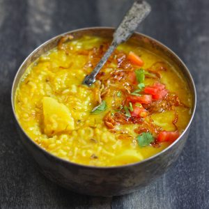 side shot of dal khichdi in a steel serving bowl