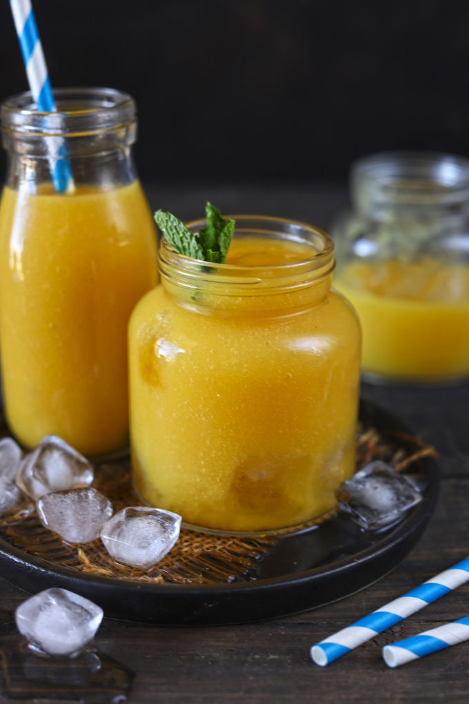 Side shot of mango iced tea in a mason jar.