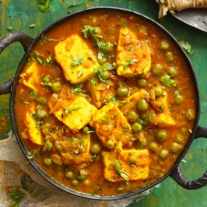 aerial shot of Indian matar paneer curry in a cast iron skillet