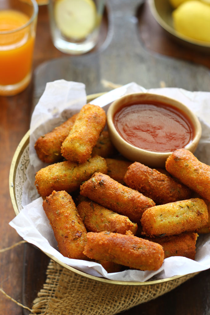 side shot of mixed vegetable cutlet along with ketchup in a bowl