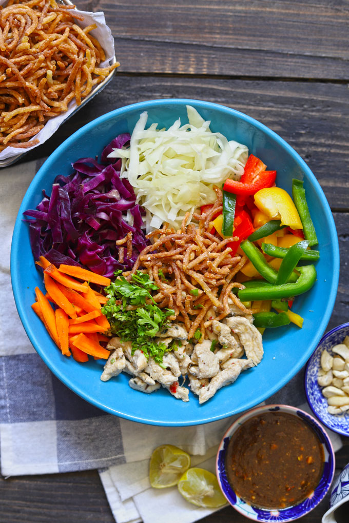 aerial shot of Asian style crispy noodle salad on a blue ceramic serving bowl