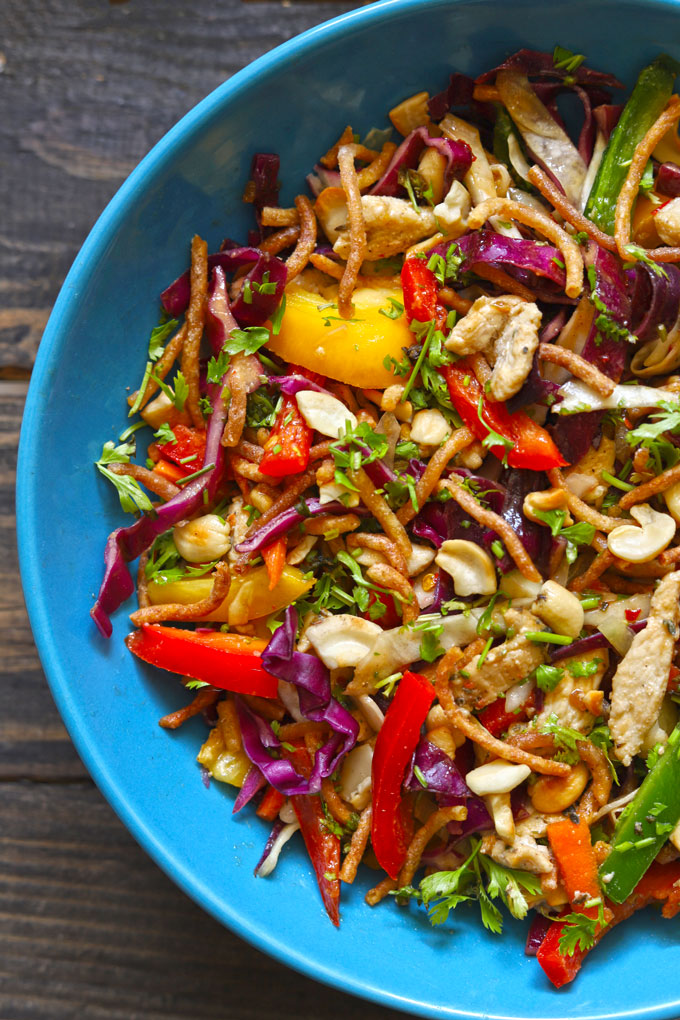 aerial shot of Asian style crispy noodle salad on a blue ceramic serving bowl