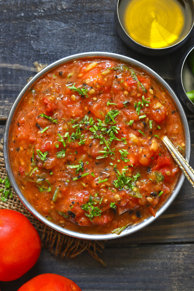 aerial shot of bhune tamatar ki chutney in a steel bowl