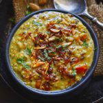 Aerial shot of shahi urad dal in a black bowl.