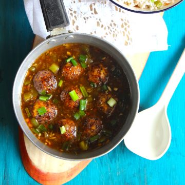 aerial shot of veg manchurian gravy in a silver saucepan