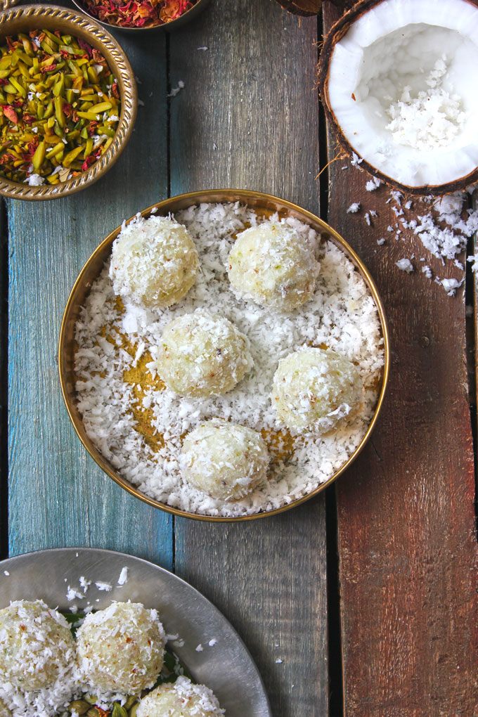 aerial shot of coconut laddo in a plate full of desiccated coconut