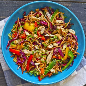 aerial shot of crispy noodle salad in a blue ceramic bowl