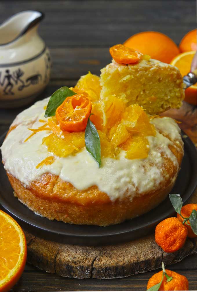 side shot of eggless orange cake and a cut out slice