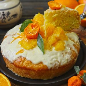 side shot of eggless orange cake and a cut out slice