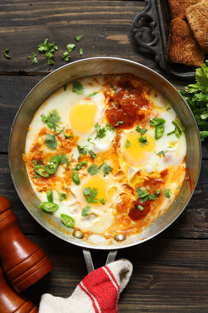 aerial shot of shakshuka on a stainless steel pan