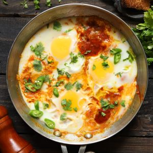 aerial shot of shakshuka on a stainless steel pan