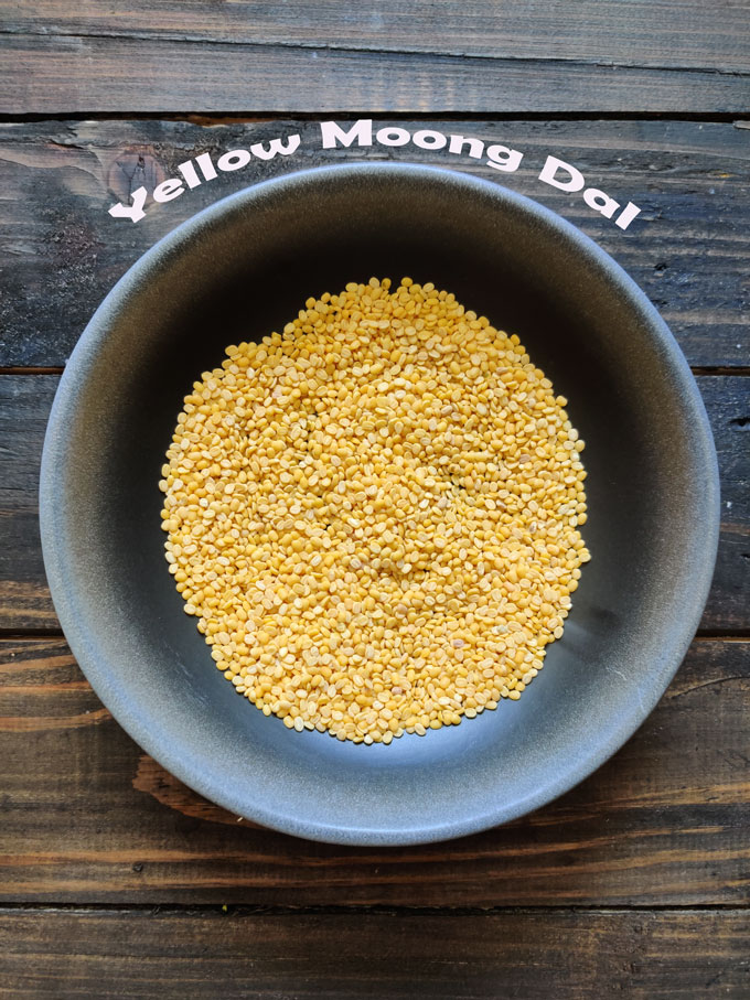 aerial shot of yellow moong dal in a black ceramic bowl