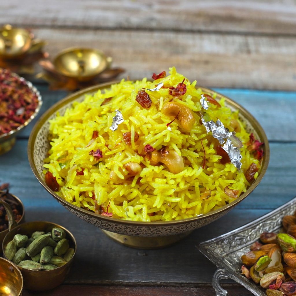 side close up shot of zarda pulao in a silver serving bowl - 68