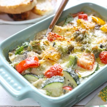 side close up shot of creamy baked vegetable in a ceramic baking dish