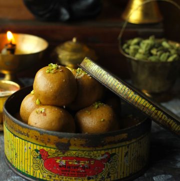 side close up shot of besan ladoo in a vintage box.