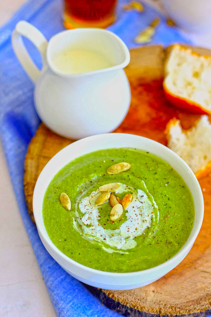 close up side shot of broccoli soup in a white ceramic bowl