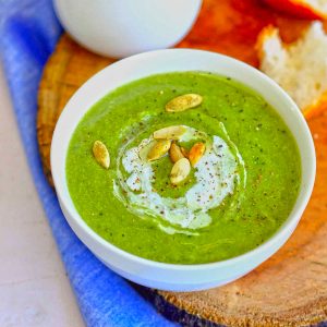 close up side shot of broccoli soup in a white ceramic bowl