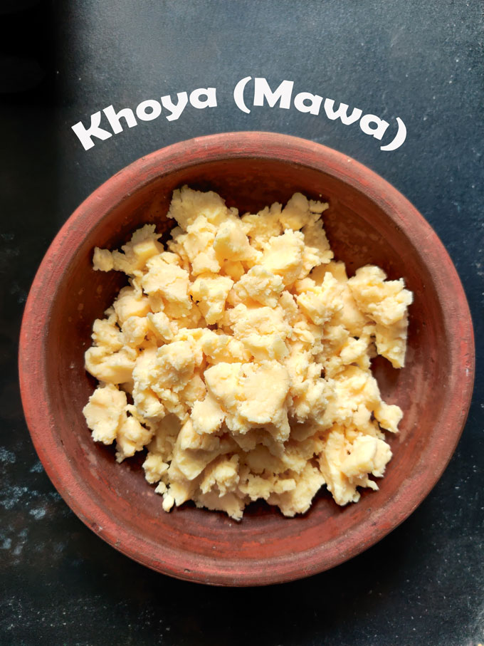 aerial shot of crumbled khoya (mawa) in a earthen bowl