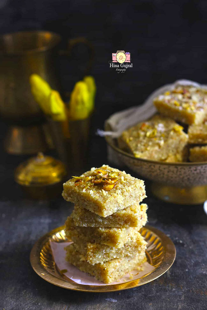 side shot of prasad panjiri stacked in a golden serving platter