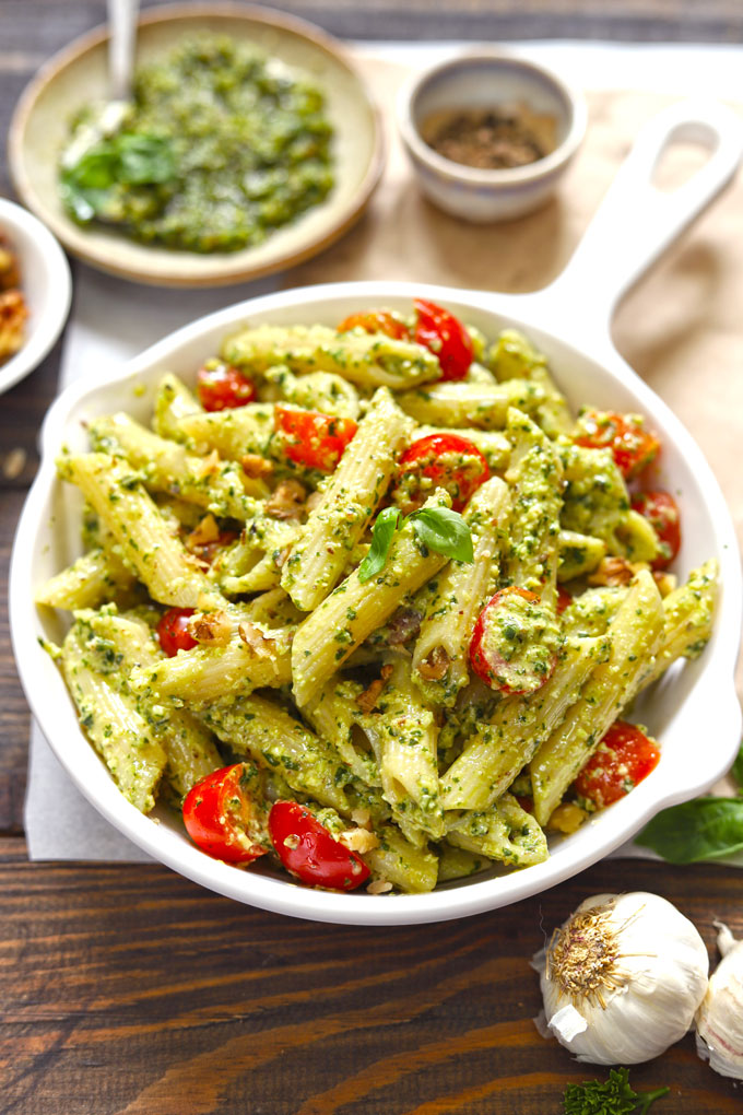 side top shot of basil pesto pasta in a white pan