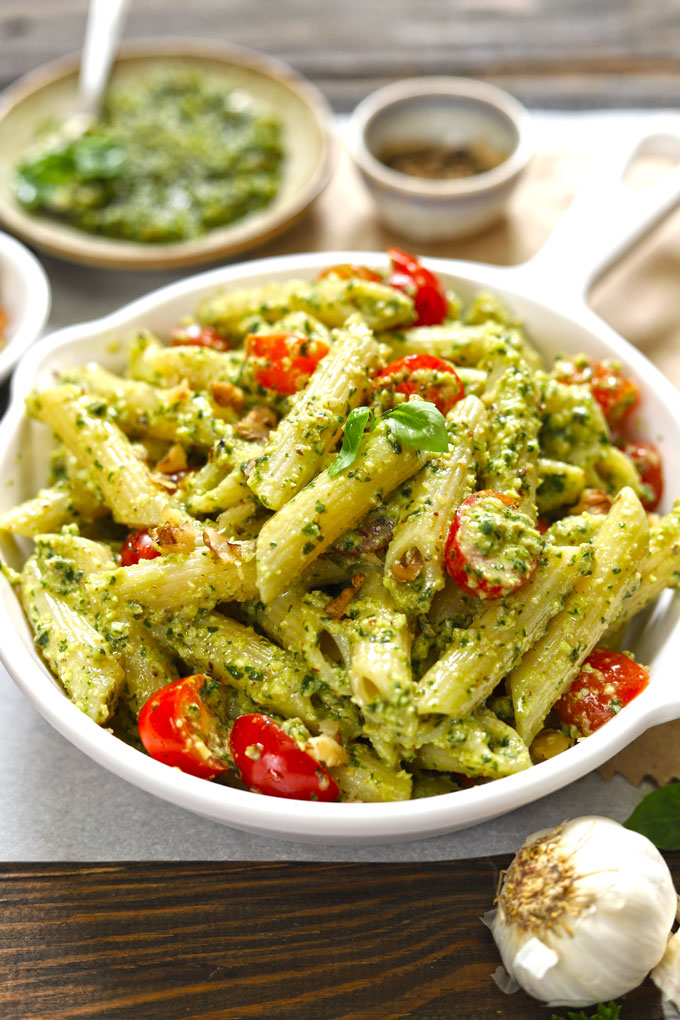 side top shot of basil pesto pasta in a white pan