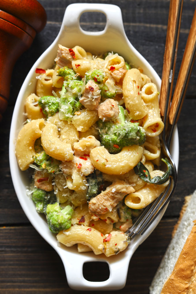 aerial shot of chicken broccoli pasta in a white oval baking dish