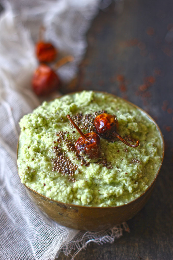 side shot of green chutney in a metal bowl