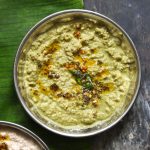 aerial shot of green coconut chutney in a steel bowl