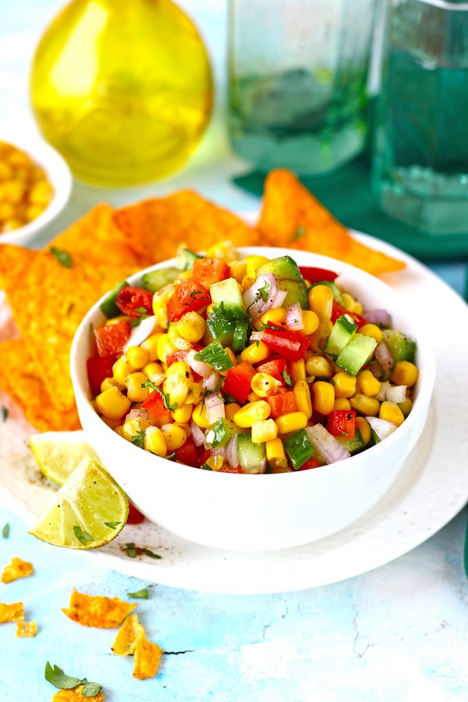 side shot of corn salad in a bowl with nachos