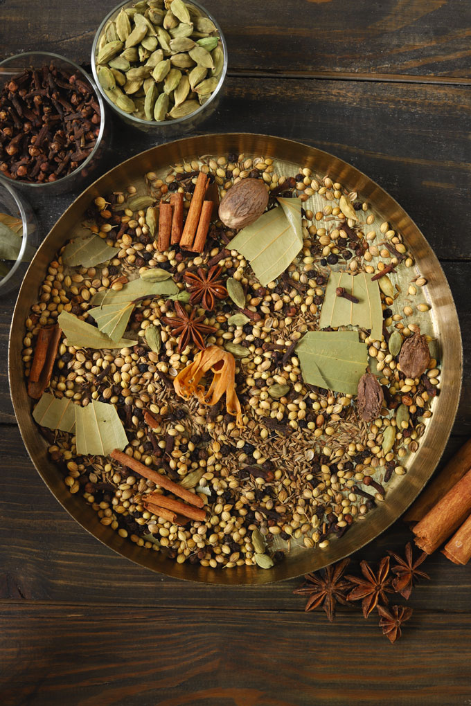 aerial shot of whole spices on a brass plate