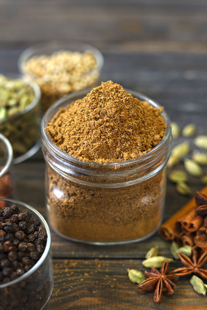 side close up shot of homemade garam masala in a glass bottle