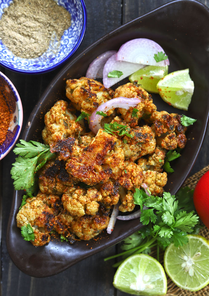 aerial shot of tandoori gobi in a black serving platter