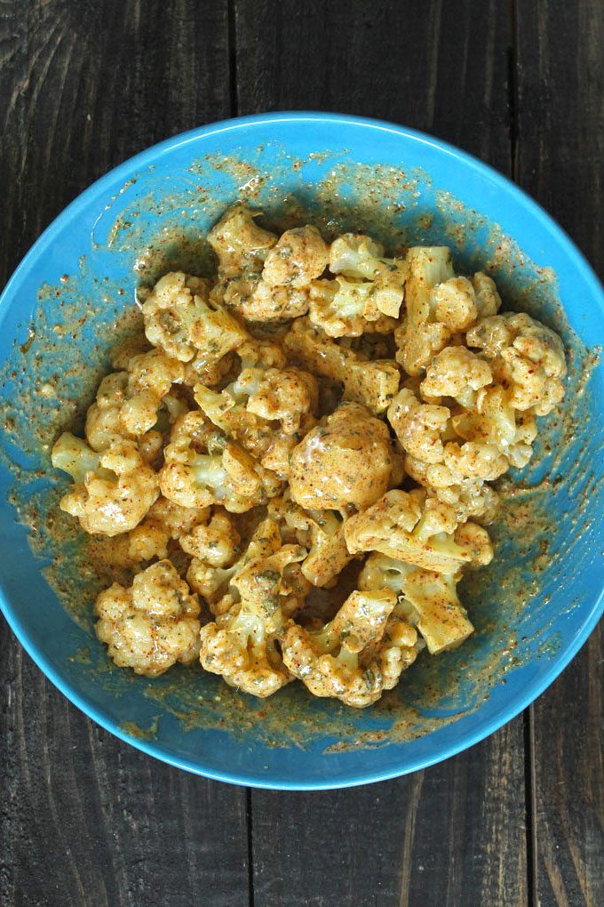 Marinated Cauliflower for gobi tikka in a blue ceramic bowl