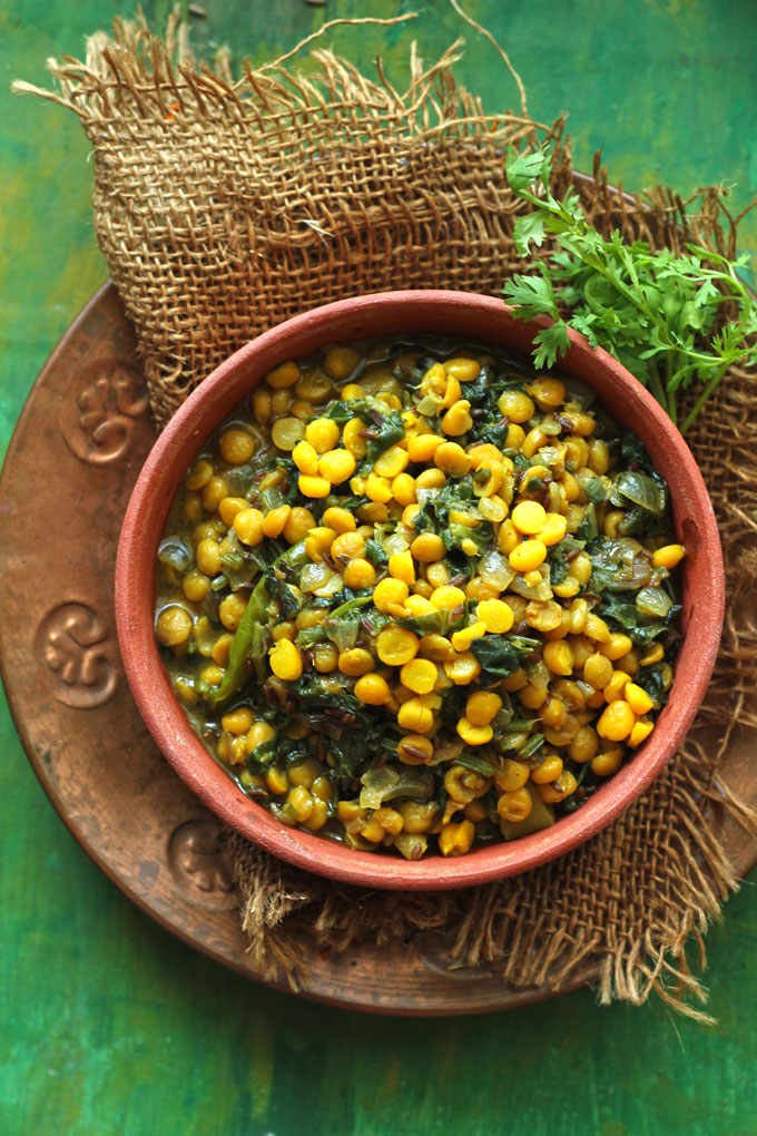 aerial shot of palak chana dal in a earthen bowl