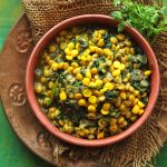 aerial shot of palak chana dal in a earthen bowl