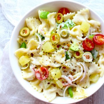 aerial shot of summer pasta salad in a white ceramic bowl