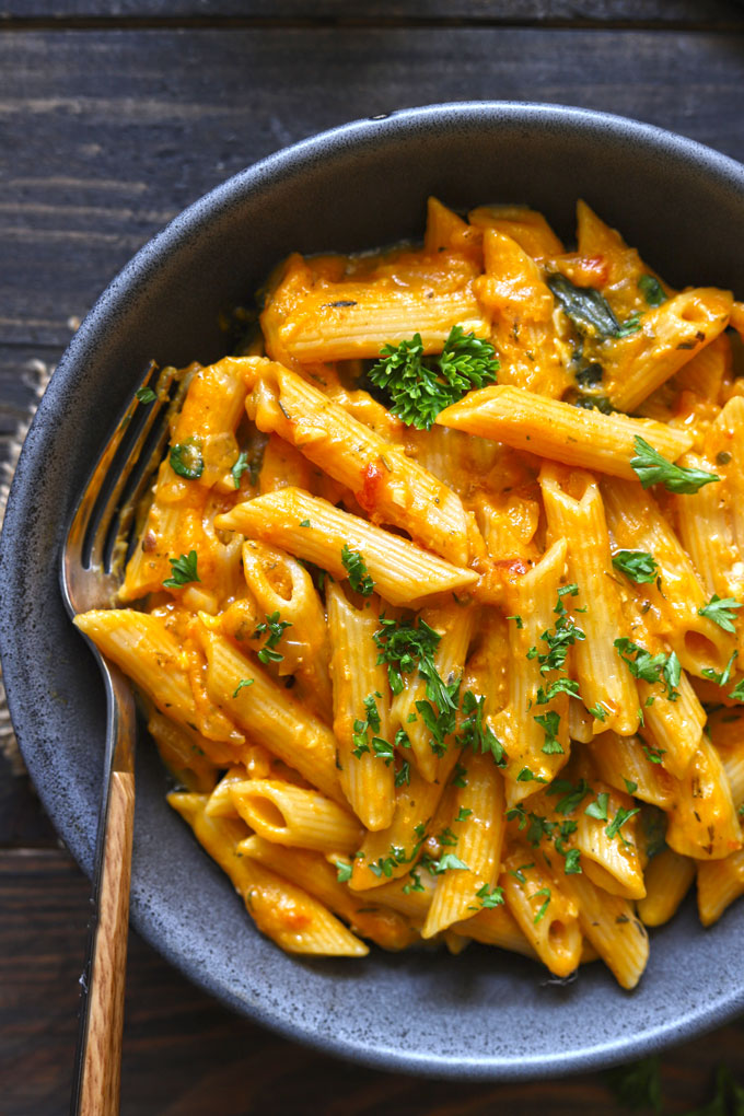 aerial shot of pumpkin pasta in a black ceramic bowl