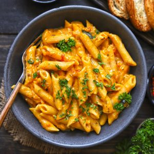 aerial shot of pumpkin pasta in a black ceramic bowl