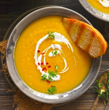 aerial shot of pumpkin soup in a grey ceramic bowl