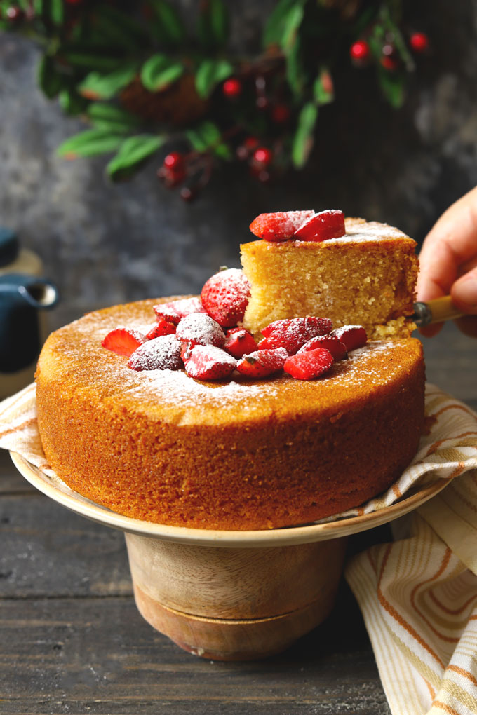 side shot of eggless sponge cake with a slice