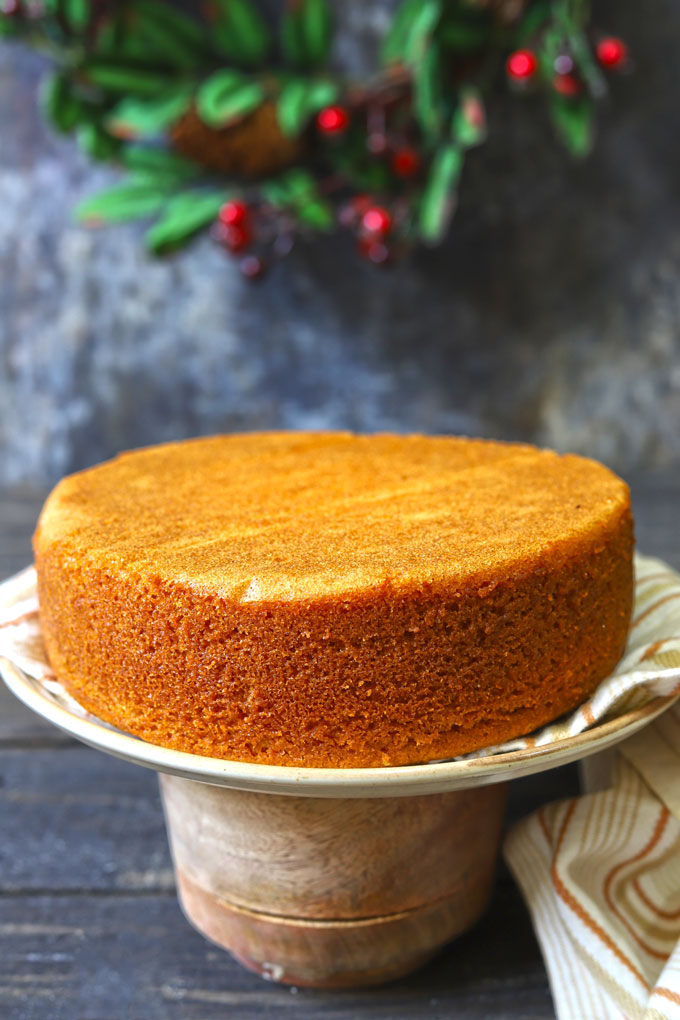 side shot of sponge cake on a cake stand