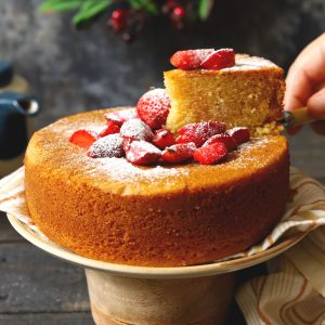 side shot of eggless sponge cake with a slice