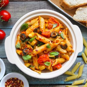 aerial shot of tomato sauce pasta in a cream ceramic bowl