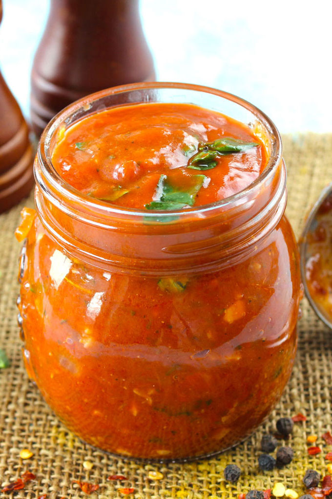 side close up shot of homemade marinara sauce in a bottle