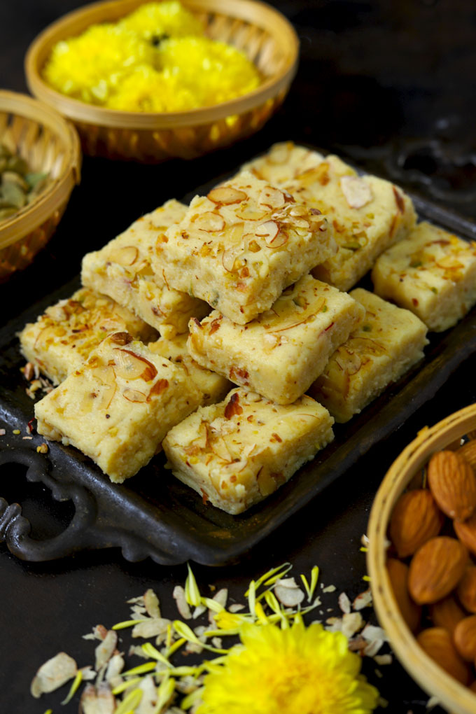 side shot of khoye ki barfi stacked on a black tray