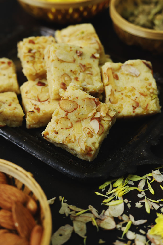 side close up shot of mawa barfi arranged on a black tray