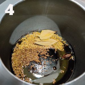 frying masala in a pressure cooker