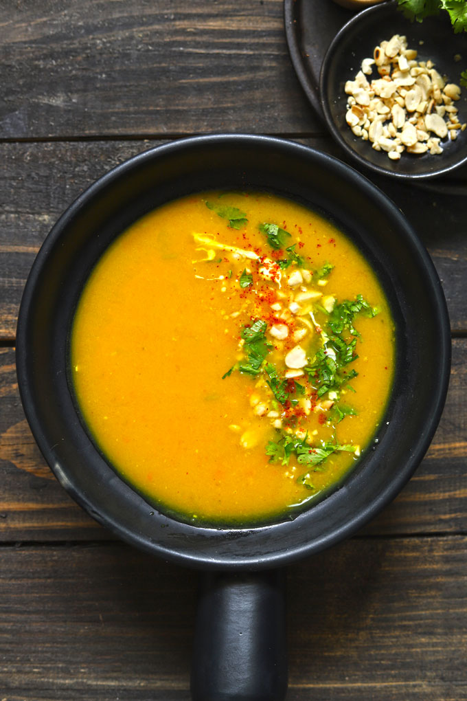 aerial shot of pumpkin soup in a black serving bowl