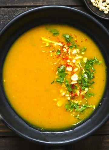 aerial shot of pumpkin soup in a black serving bowl