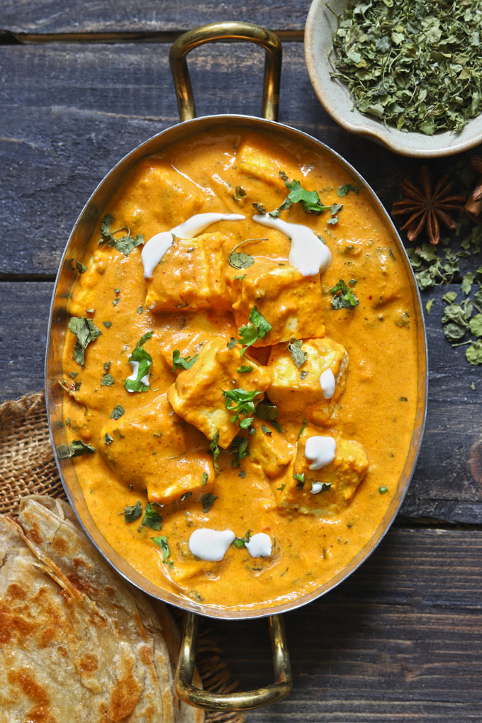 aerial shot of paneer makhani in an oval serving platter